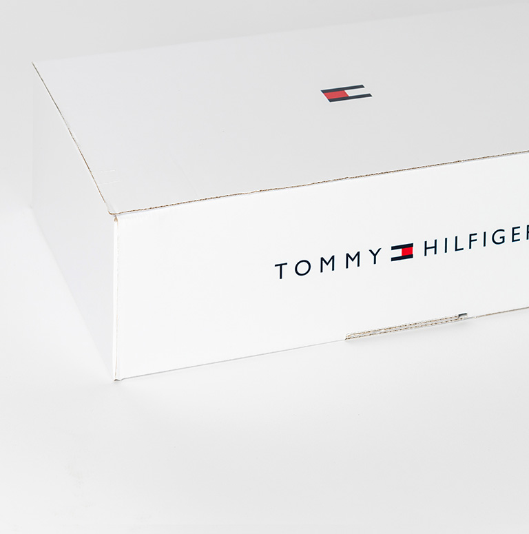 Folding carton made of corrugated cardboard with printed outside of a well-known brand: Tommy Hilfiger.